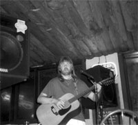 Monty Milne with PA system and guitar at Binni and Flynn's in Wayne, PA